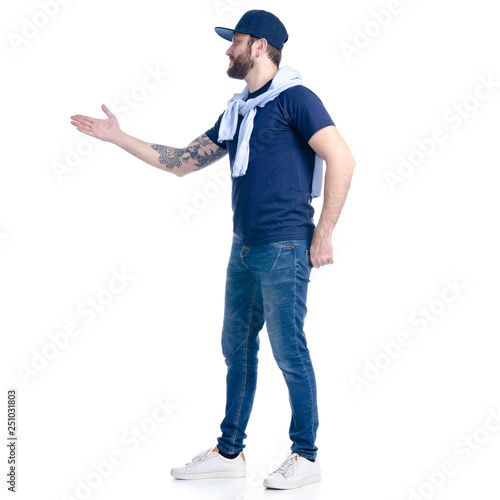 Man in jeans, t-shirt and cap smiling showing on white background isolation