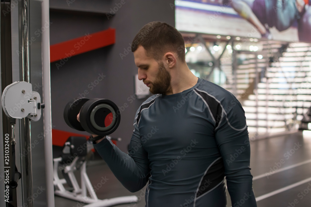 Man in the gym with kettlebells and weights.