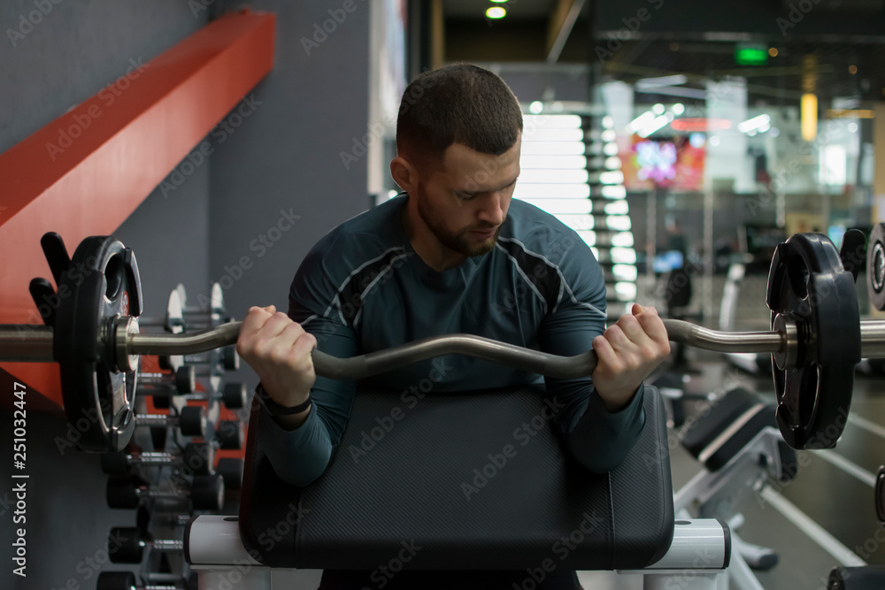 Man in the gym with kettlebells and weights. Man in the gym with kettlebells and weights.