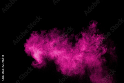 Pink powder explosion on black background.