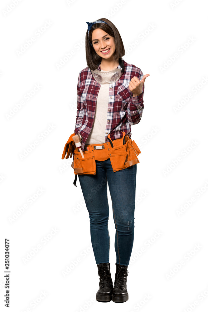 A full-length shot of a Young worker woman giving a thumbs up gesture and smiling over isolated white background A full-length shot of a Young worker woman giving a thumbs up gesture and smiling over isolated white background