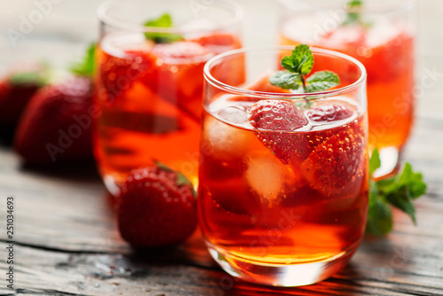 Fresh summer cocktail with ice, strawberry and mint