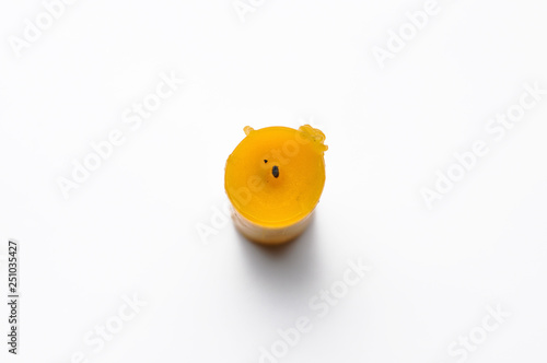 Yellow candle isolated on a white background photo