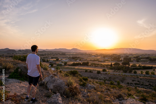 Man watching the sunset in a mountain