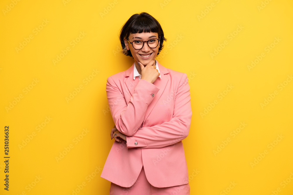 Modern woman with pink business suit with glasses and smiling Modern woman with pink business suit with glasses and smiling
