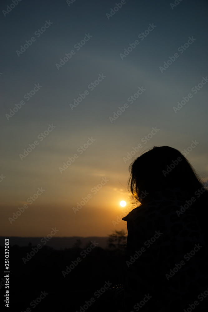 silhouette of a woman at sunset silhouette of a woman at sunset
