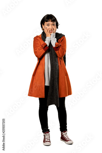 A full-length shot of a Short hair woman with coat nervous and scared stretching hands to the front over isolated white background
