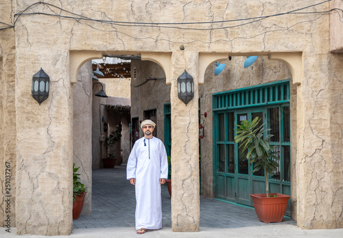 Arab Man walking in old Al Seef area of Dubai © katiekk2