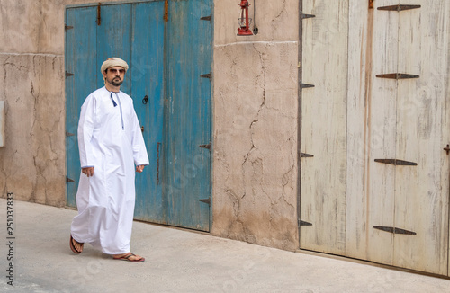 Arab Man walking in old Al Seef area of Dubai