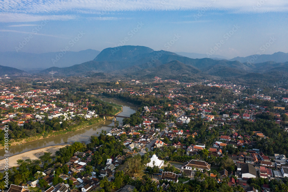 (view from above) Stunning aerial view of the beautiful Luang Prabang city with the Nam Khan river flowing through.