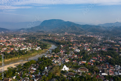 (view from above) Stunning aerial view of the beautiful Luang Prabang city with the Nam Khan river flowing through.