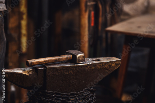 closeup of a blacksmith's hammer on the anvil.