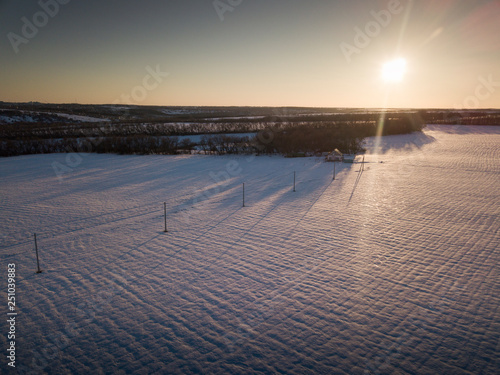 Aerial view on road and forest landscape in winter season.