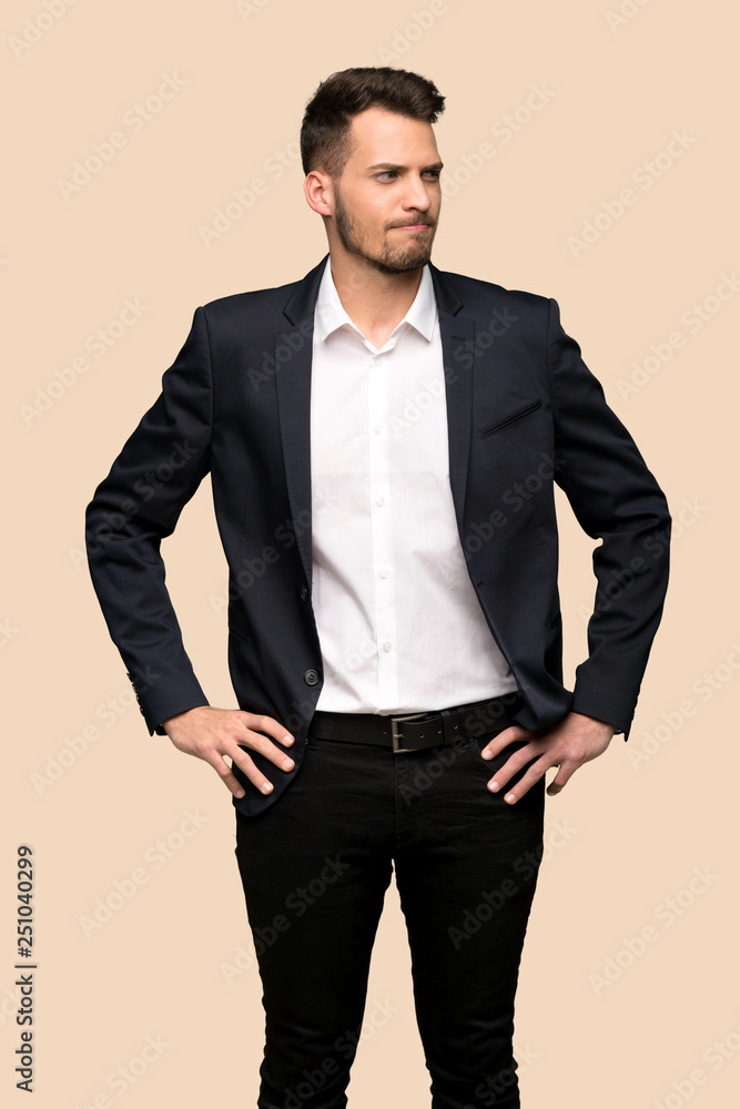 Fototapeta premium Handsome business man thinking over ocher background