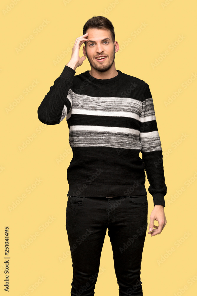 Handsome man has just realized something and has intending the solution over yellow background Handsome man has just realized something and has intending the solution over yellow background