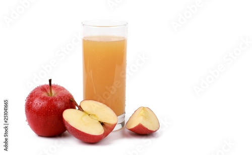  naturally cloudy apple juice - sliced ​red apples with drops of water and a glass of naturally cloudy apple juice in front of white background