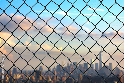 New York city behind steel mesh wire fence. Concept