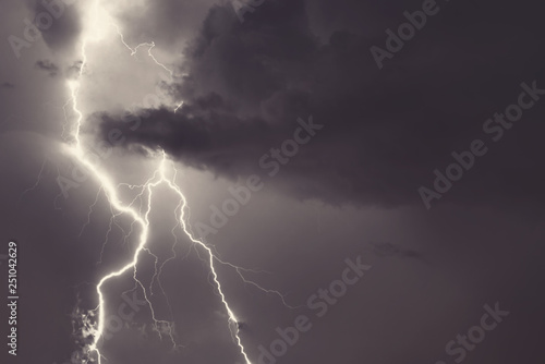 Lightning strike on the night cloudy sky