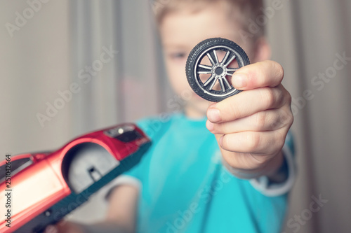boy broke the toy. broken wheel from the car