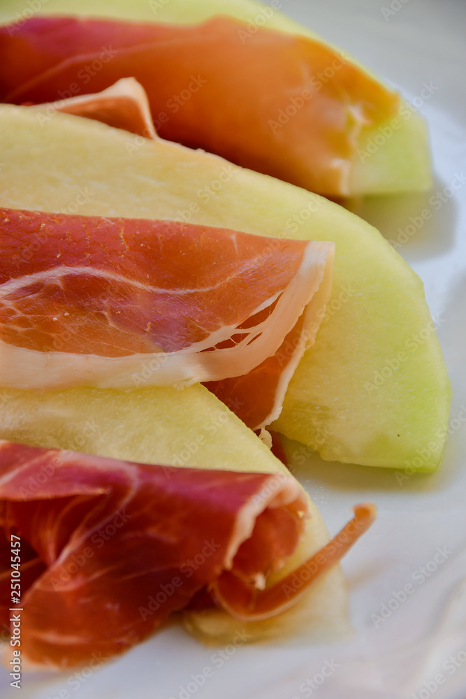  traditional Italian appetizer of prosciutto and melon. selective focus and copy space