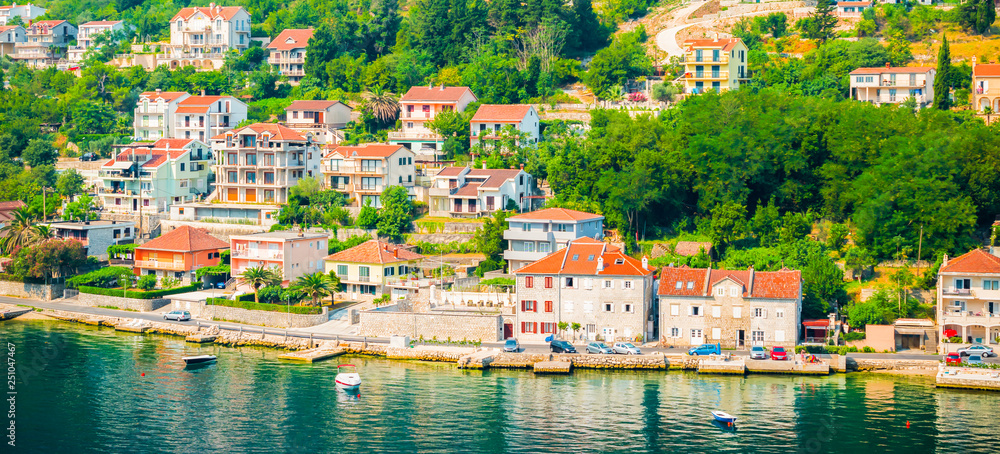 Village on the bay of Kotor in Montenegro. Panoramic view of traditional buildings along the waterfront.