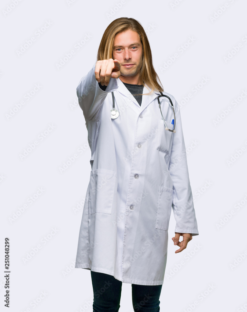 Doctor man points finger at you with a confident expression on isolated background Doctor man points finger at you with a confident expression on isolated background