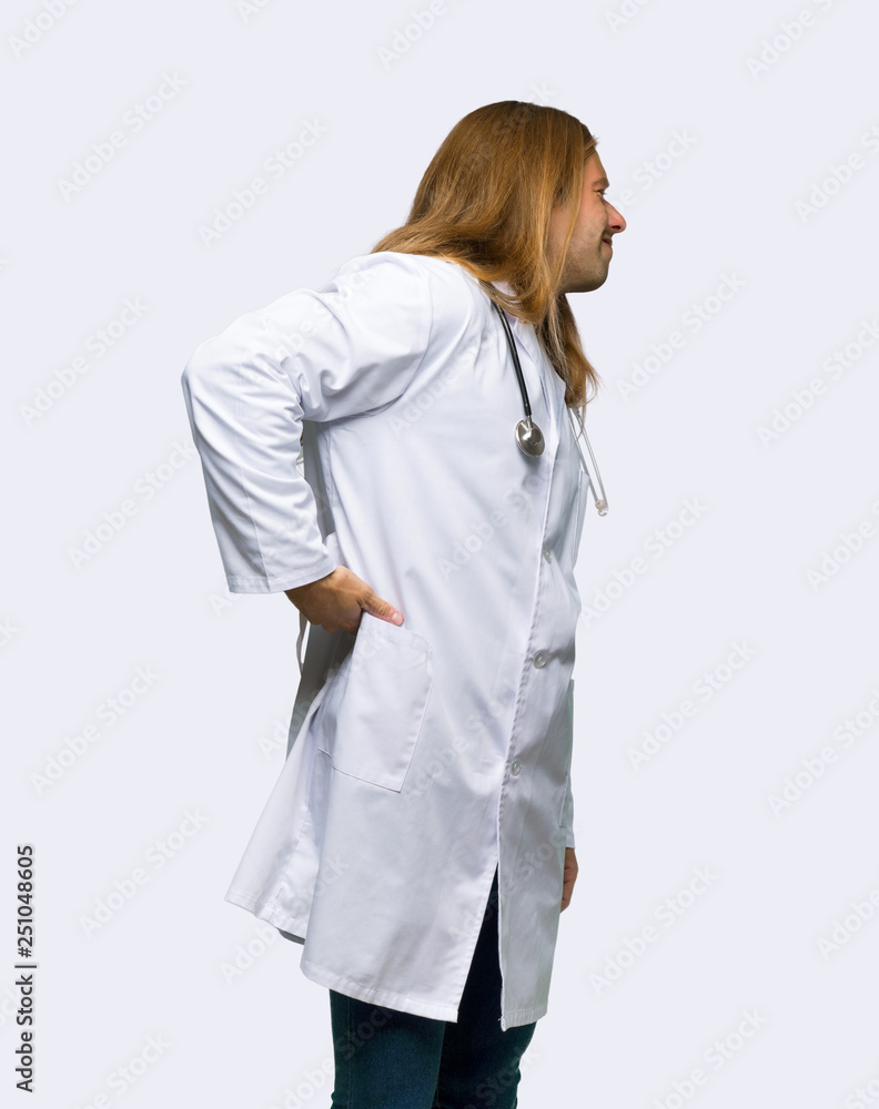 Doctor man suffering from backache for having made an effort on isolated background Doctor man suffering from backache for having made an effort on isolated background