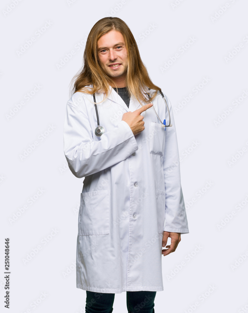 Doctor man pointing to the side to present a product on isolated background Doctor man pointing to the side to present a product on isolated background