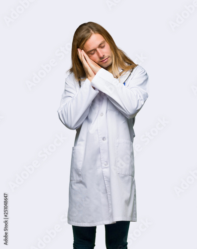 Doctor man making sleep gesture in dorable expression on isolated background © luismolinero