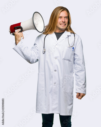 Doctor man taking a megaphone that makes a lot of noise on isolated background
