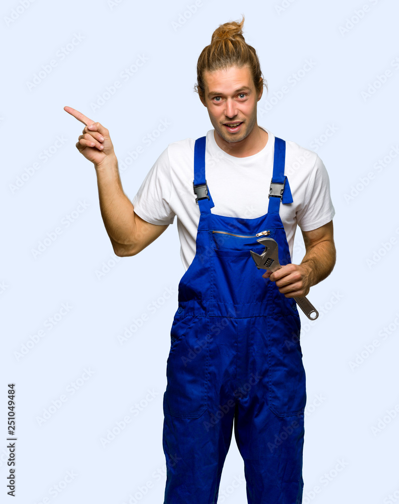 Workman pointing finger to the side and presenting a product on isolated background Workman pointing finger to the side and presenting a product on isolated background