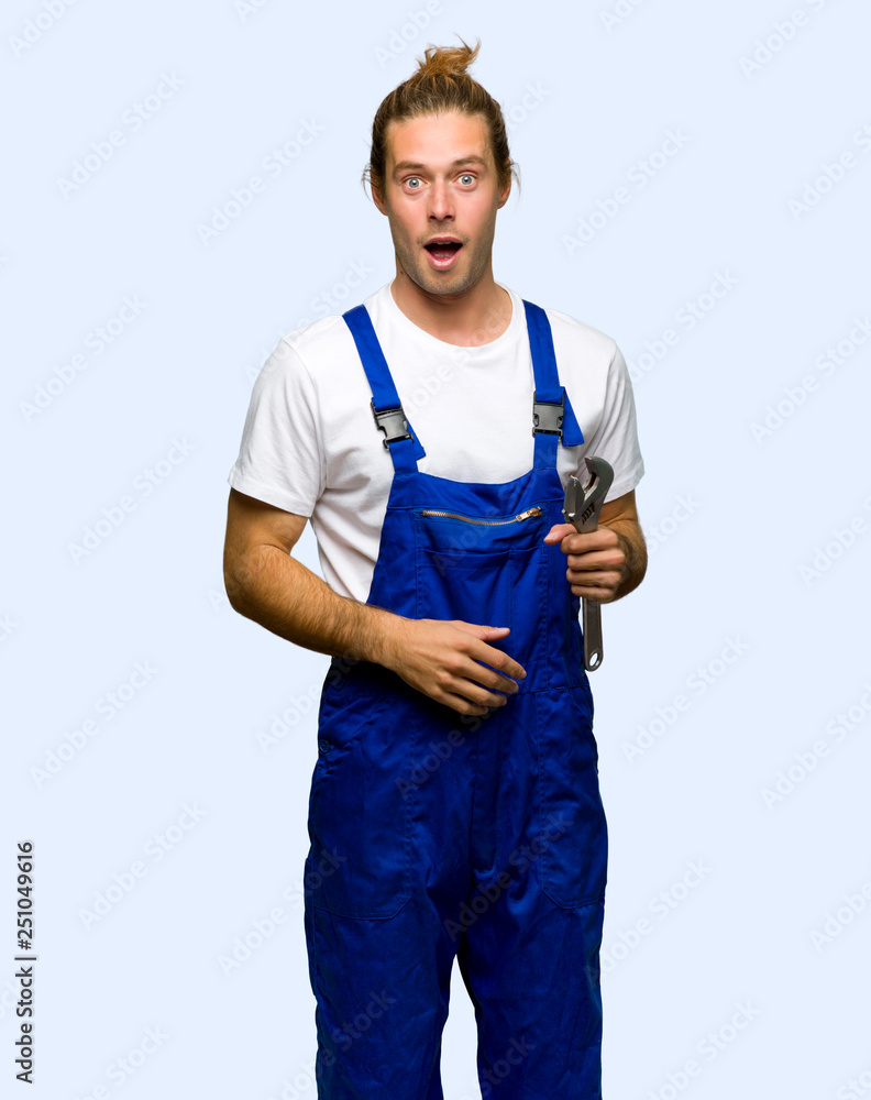 Workman with surprise and shocked facial expression on isolated background Workman with surprise and shocked facial expression on isolated background