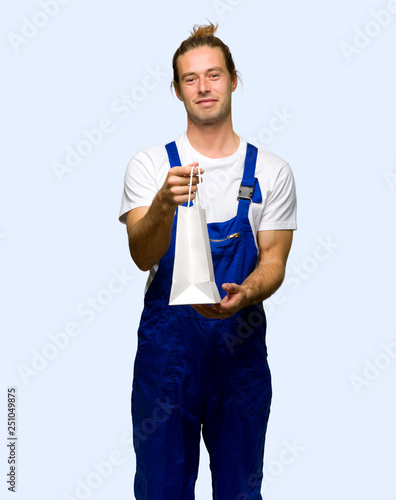 Workman holding a lot of shopping bags on isolated background