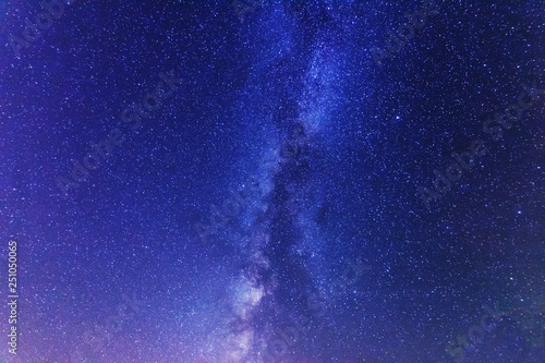 A bright starry night with millions of stars and a galaxy Milky way from the altitude of the mountain ranges.