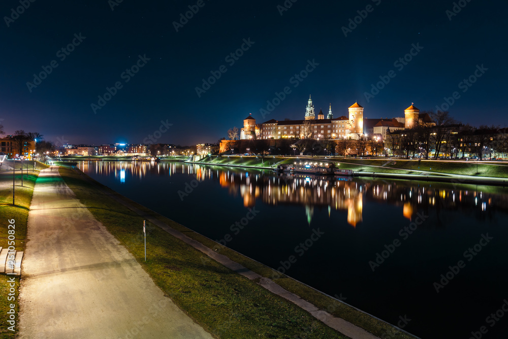 The Royal Wawel Castle as seen from another bank of Vistula. Krakow is the most famous landmark in Poland. Night view