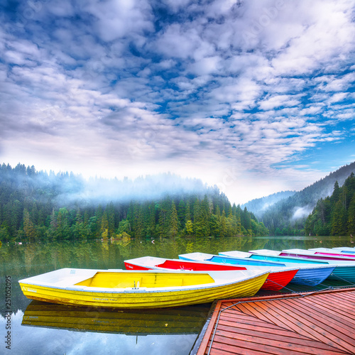 Boats on majestic mountain lake Lacul Rosu or Red Lake or Killer Lake