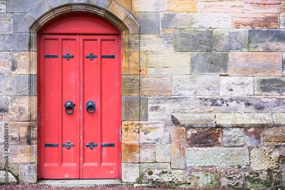 Red old wooden door rustic ancient house entrance in Culross Red old wooden door rustic ancient house entrance in Culross