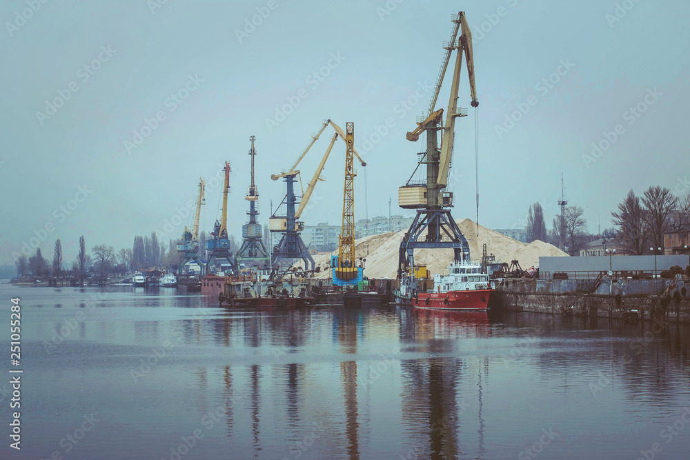 Cargo dock ship-lifting cranes in the harbor, Cargo river port terminal container