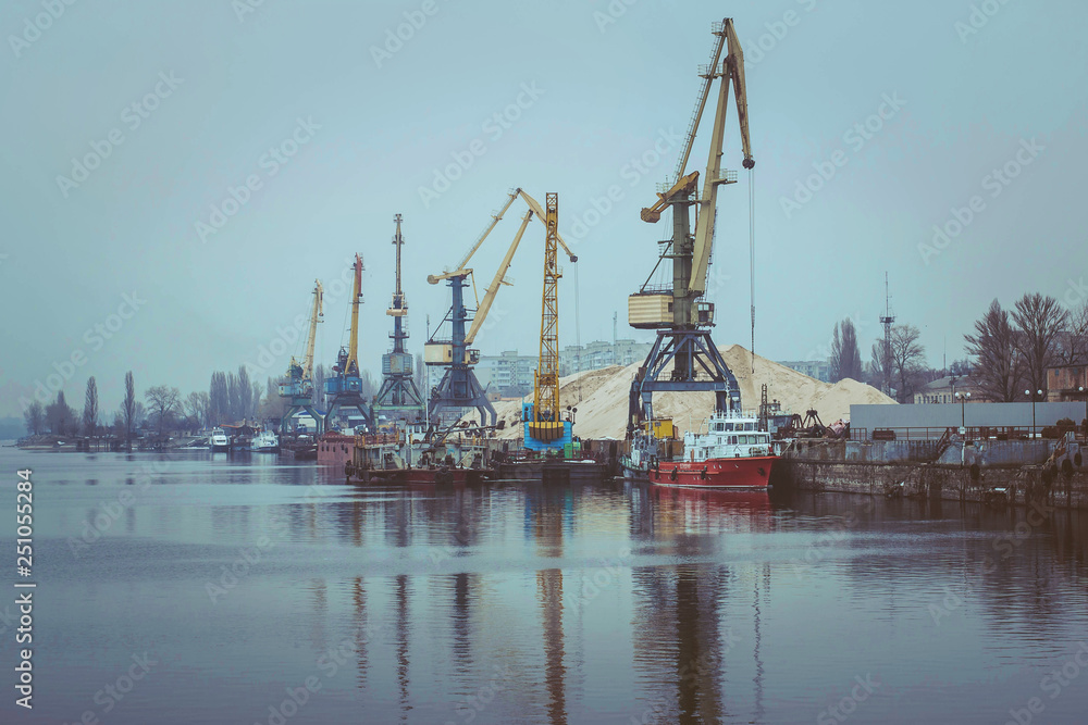 Cargo dock ship-lifting cranes in the harbor, Cargo river port terminal container Cargo dock ship-lifting cranes in the harbor, Cargo river port terminal container