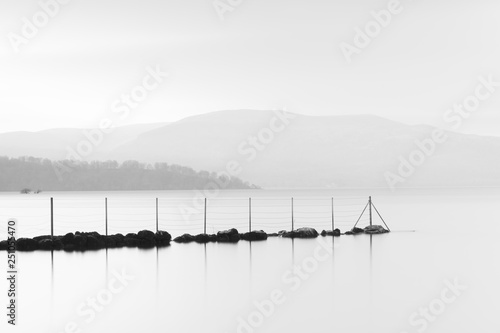 Sunset at Loch Lomond black and white graphic beautiful calm peaceful landscape scenic view reflection of jetty in water