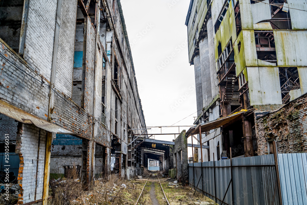 Old factory ruin and broken windows. Industrial building for demolition.