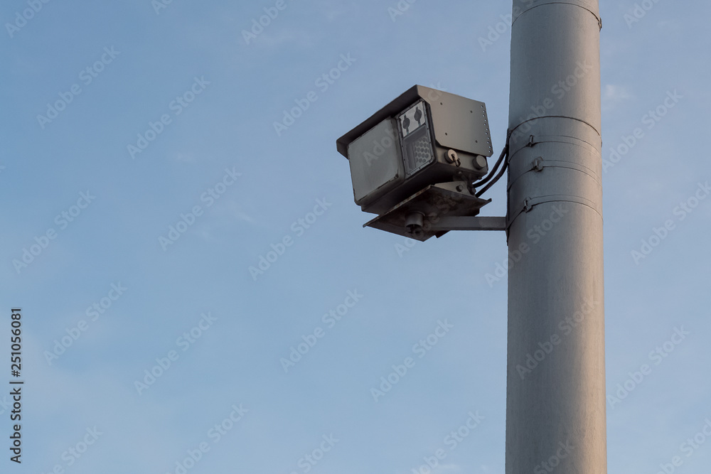 Traffic police speed radar on pole in city on road