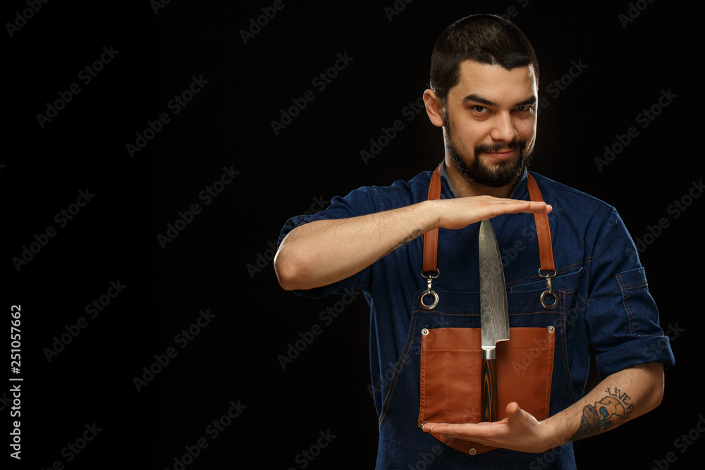 Man with lifted eyebrow keeping metallic knife between both hands. Man with lifted eyebrow keeping metallic knife between both hands.