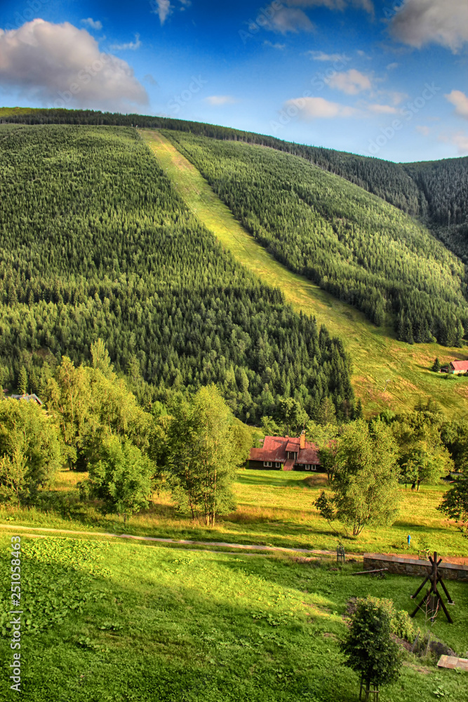 Obraz premium Valley in czech national park Giant mountain- Krkonose. The town with a lot of wooden huts in Spindleruv Mlyn. Czech nature is beautiful.
