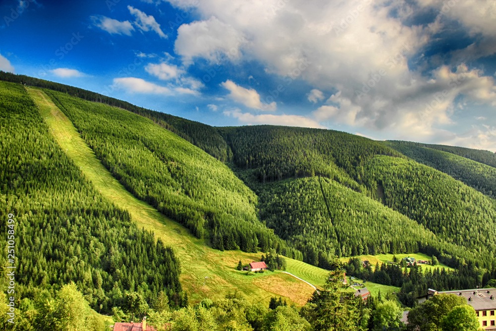 Obraz premium Valley in czech national park Giant mountain- Krkonose. The town with a lot of wooden huts in Spindleruv Mlyn. Czech nature is beautiful.