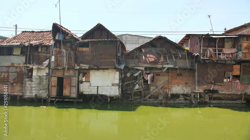 Slum area on the riverbank in Jakarta. Indonesia. photo