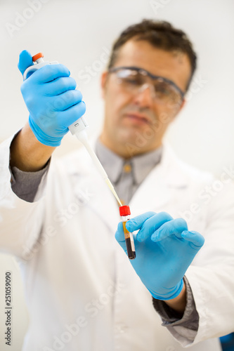 Mature Hispanic scientist working at his laboratory