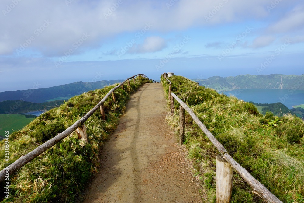 A thin hiking trail on top of the Boca Inferno Mountain in Sao Miguel, Azores overlooking sete cidades lakes