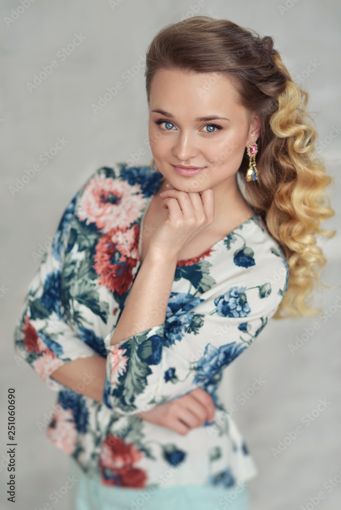 portrait of a beautiful young woman with blond curly curls tender elegant girl with expressive blue eyes in the studio. Fashion photo portrait of a beautiful young woman with blond curly curls tender elegant girl with expressive blue eyes in the studio. Fashion photo