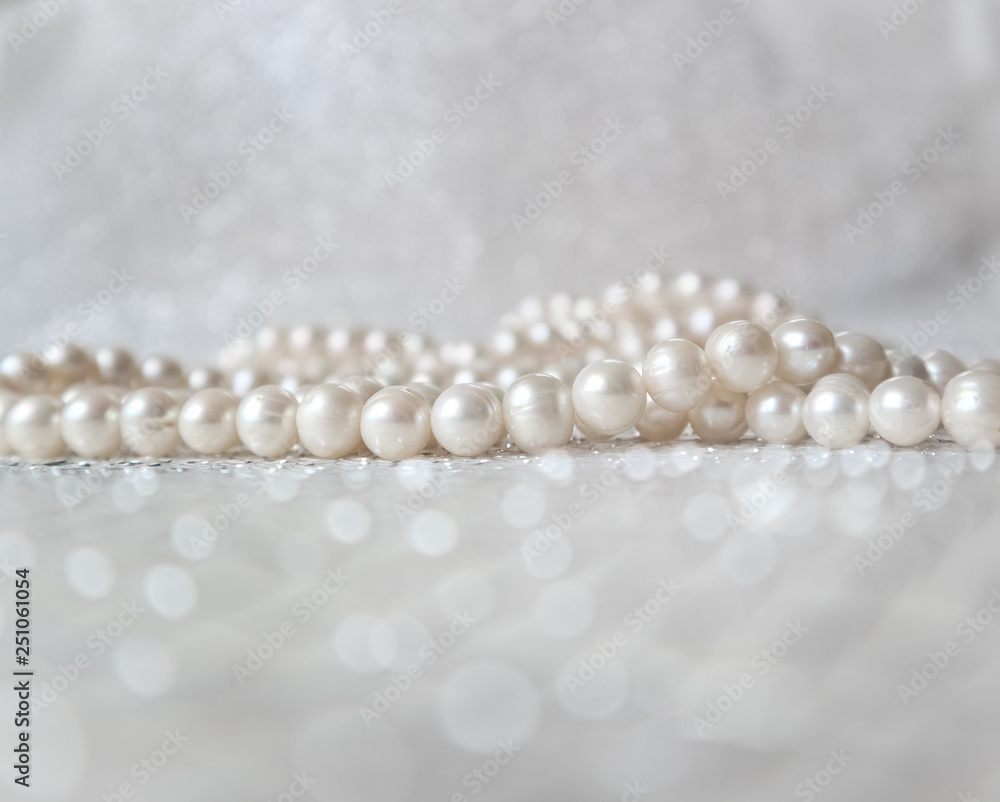 Nature white pearl beads on sparkling background Nature white pearl beads on sparkling background